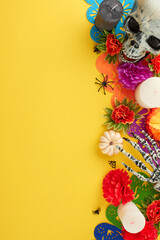 Honor Mexican traditions with an unforgettable celebration. Top view vertical shot of skull, skeleton arm, candles, carnations, marigolds, garland, scary spiders on yellow background with promo panel