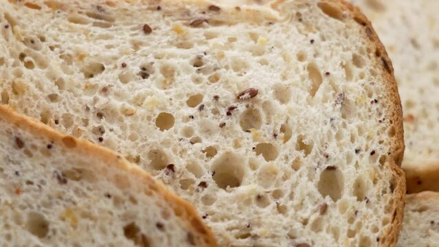 Gluten free sliced white bread with seeds for celiacs. Dietary healthy food. Macro. Rotation