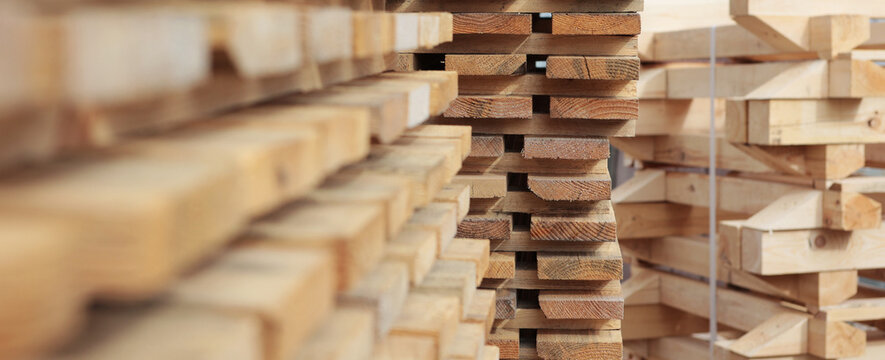 Pallets for building materials. Wooden stands for transportation of building materials. Wooden pallets are stacked. Narrow banner.Selective focus.