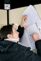 Girl copying homework on playground