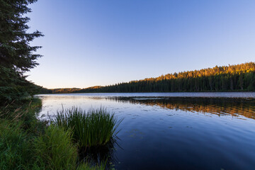 Tranquil morning sunrise over Andy Bailey Lake, British Columbia, Canada