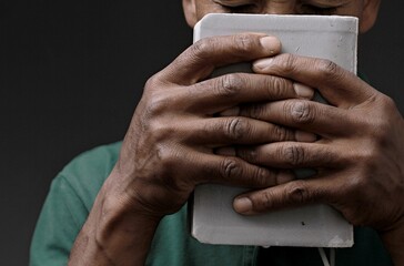 Obraz premium man praying to god with hands together on grey background with people stock image stock photo 