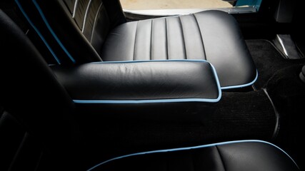 Black leather arm rest inside a car