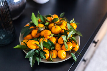 food, healthy eating and fruits concept - close up of mandarins on plate