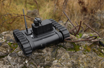 ground robot. in a field on a contaminated territory. Search and rescue robot with tracks.