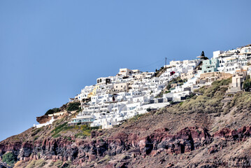 Fira, Greece - July 20, 2023: Domed churches and surrounding buildings in the town of Fira on the...