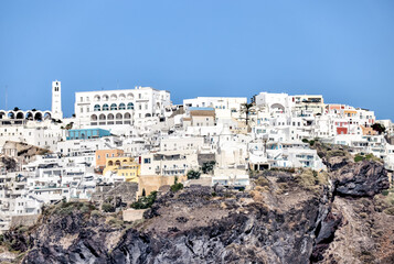Fira, Greece - July 20, 2023: Domed churches and surrounding buildings in the town of Fira on the...