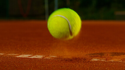 Bouncing tennis ball on clay court, freeze motion