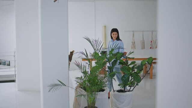 Girl walking art hall in modern business center. Design store visitor looking