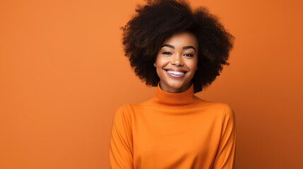 Obraz na płótnie Canvas Stunning African American model in vibrant orange attire, radiating positivity against a matching background. Ideal for fashion, social media, advertising, and corporate promotion.