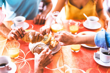 Group of friends having breakfast at  bar eating croissants and drinking coffee-group of people taking sweet pastries from the pastry shop together sitting at the hotel table in garden-Bistrò Concept 