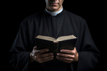 A priest dressed in a cassock holding and reading a Bible in his hands.generative ai
 - obrazy, fototapety, plakaty