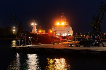 Fototapeta na wymiar Ocean cargo ship loading at dock.