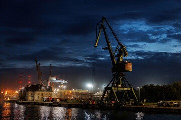 Fototapeta na wymiar Cargo cranes in the docks.