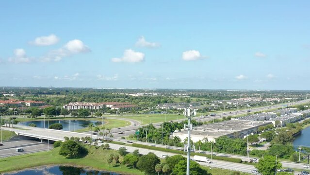 Drone shot of South Florida with lakes and palm trees, clouds with blue skies