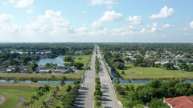 Drone shot of South Florida with lakes and palm trees, clouds with blue skies