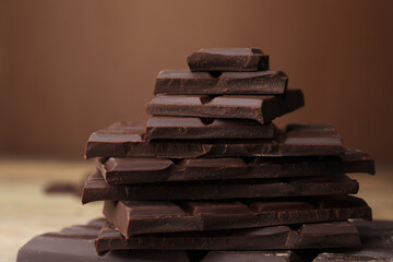 Pieces of tasty chocolate on blurred background, closeup - Powered by Adobe