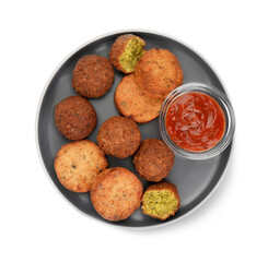 Plate with delicious vegan cutlets, falafel balls and sauce isolated on white, top view