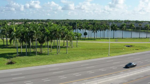 Drone shot of South Florida with lakes and palm trees, clouds with blue skies