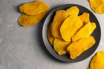 Dried mango fruit on gray background. No added suger healthy snack.