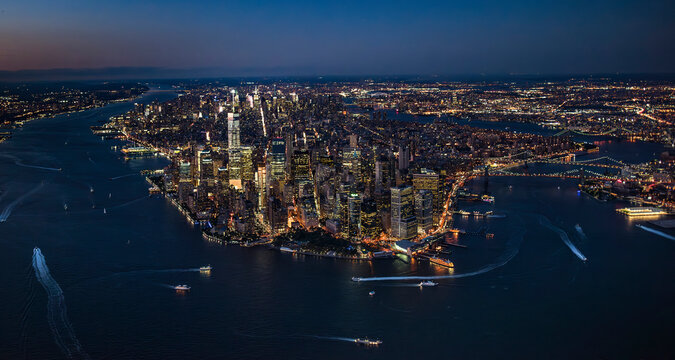 Fototapeta Aerial view of lower Manhattan illuminated at night