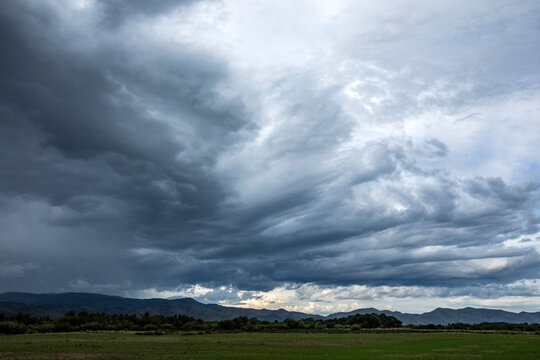 USA, Idaho, Bellevue, Storm clouds above landscape with meadow
