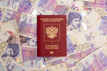 Russian red biometric passport on paper banknotes. 100 GEL. Georgian lari. Concept of immigration...