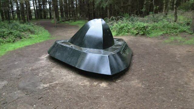 Circling realistic flying saucer in Rendlesham forest UFO trail woodland park clearing