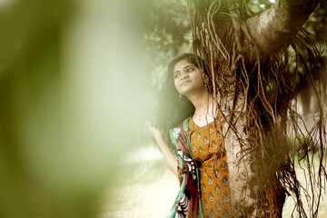 Happy woman near banyan tree