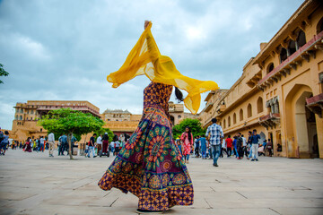 Woman dancing at courtyard of Amber Fort, Jaipur, India.
