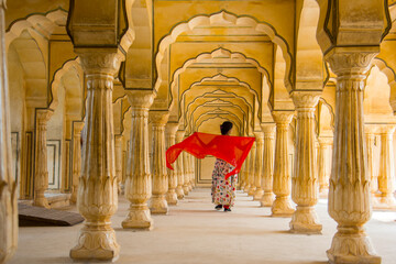 Young female tourist dancing at Pillars room of Amber Fort, Jaipur
