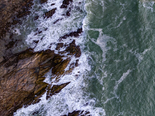Aerial view seashore with mountains at Phuket Thailand, Beautiful seacoast view at open sea in summer season,Waves crashing on seashore rocks