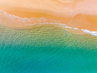 Fototapeta na wymiar Summer sea nature background,Aerial view of Waves crashing on sandy shore,Sea surface ocean waves background