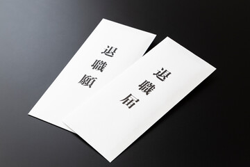 黒背景に退職届と退職願い