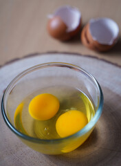 fresh two raw egg yolks in a glass bowl at wooden background.
Egg Yolk contain protein, vitamins, minerals, omega3 and other nutrients. 