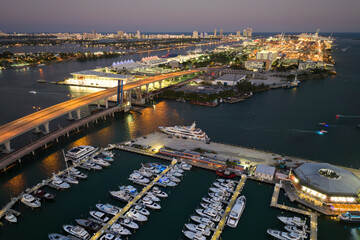 Expensive yachts and motorboats docked in Biscayne Bay harbor in downtown district of Miami,...