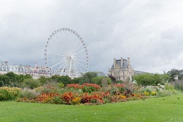 The famous and central Tuileries Garden in Paris on a cloudy day, with a Ferris wheel