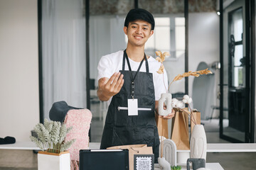Sales man asking customer to come looking at his craft product while smiling