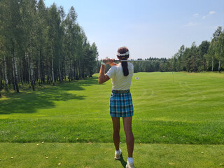 Rear view of golfer woman after golf piggyback
