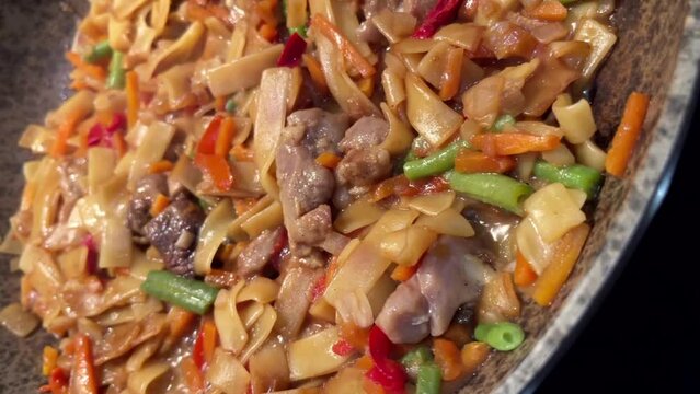 Yakisoba noodles meat vegetables frozen food cooked in a frying pan video