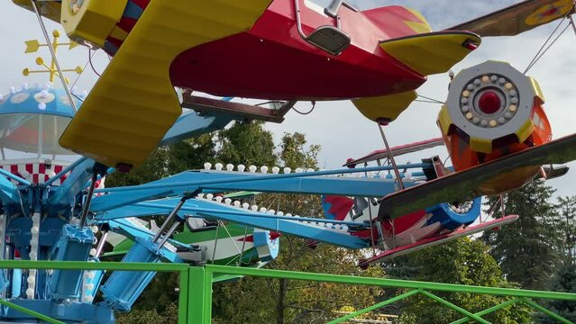 brave pilot toddler child in amusement park, attraction colorful airplanes will lift children Divo Ostrov, St. Petersburg, Russia