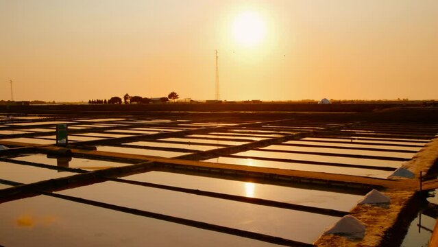 The salt ponds or salt fields of Aveiro, Portugal by sunset, perfect shimmering mirrors that capture the essence of this coastal town