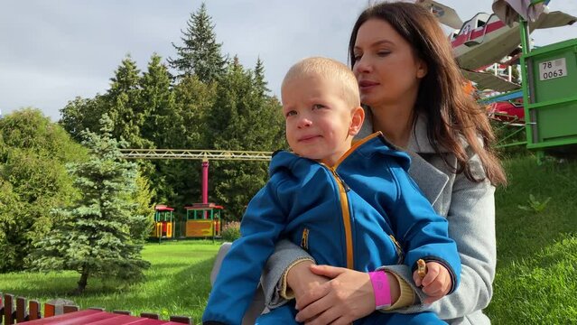 mother with toddler child in amusement park Divo Ostrov, St. Petersburg, Russia