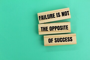 wood and quotes the word Failure is not the opposite of success. the concept of inspiration or self-motivation to succeed