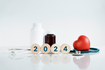 Wooden cubes with Text 2024 and Red heart and stethoscope, Happy New Year for health care.heart...