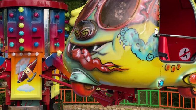 brave pilot toddler child in amusement park, attraction colorful airplanes will lift children Divo Ostrov, St. Petersburg, Russia