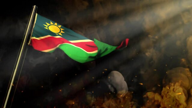 waving Namibia flag on smoke and fire with sun rays - problems concept