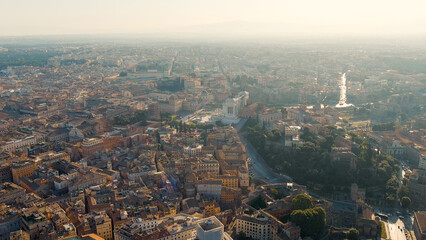 Rome, Italy. Vittoriano - Monument to the first king of Italy, Victor Emmanuel II. Flight over the city. Panorama of the city in the morning. Backlight. Summer, Aerial View