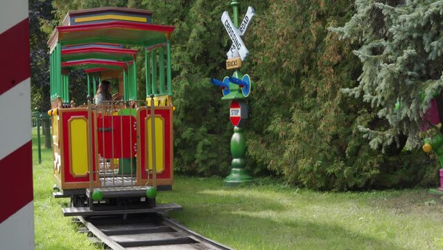 mother with toddler child in amusement park Divo Ostrov, St. Petersburg, Russia, attraction train Chukh-chukh