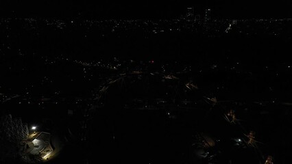 Aerial: Revealing Ferris wheel with Mexico City skyline at night